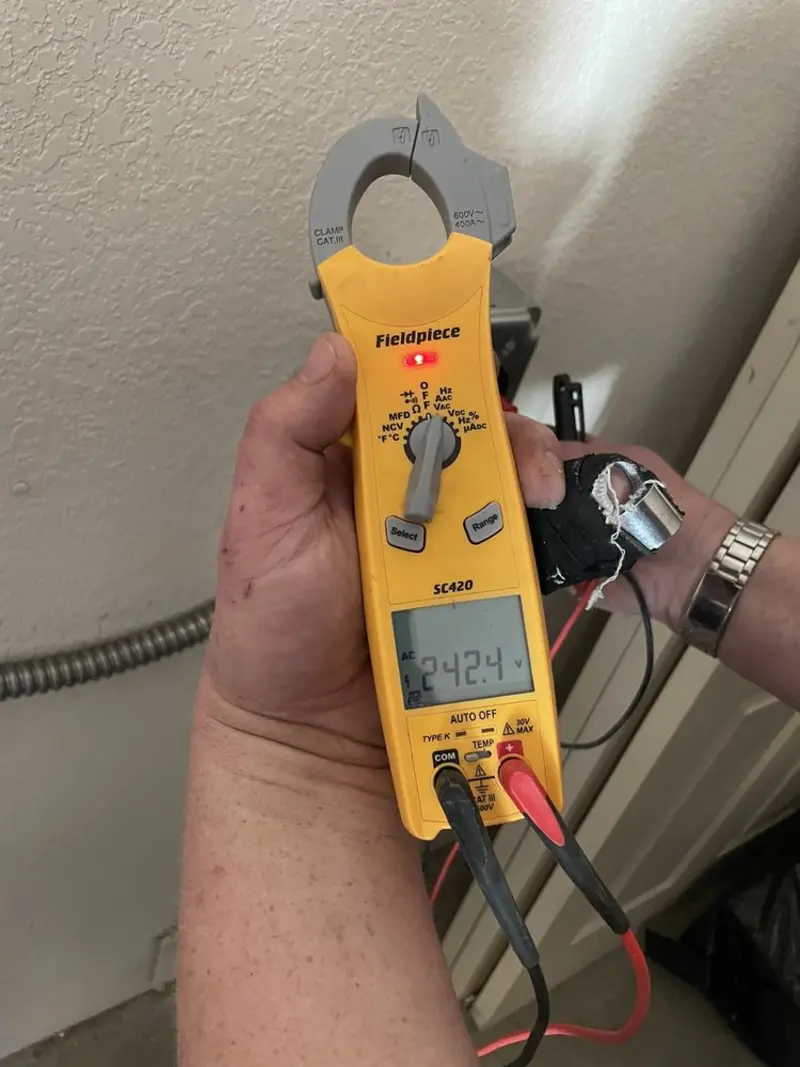 Voltage testing with clamp meter during Outlet Installation in Broussard